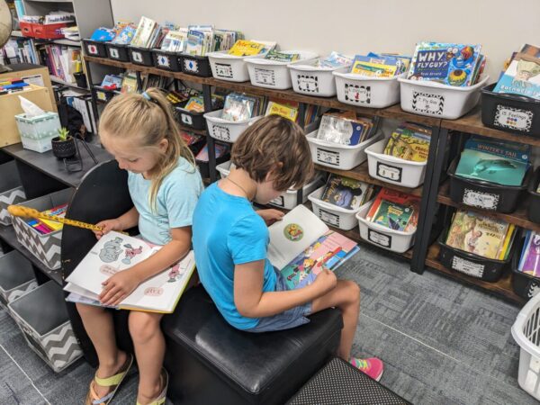 Students reading independently, side by sid